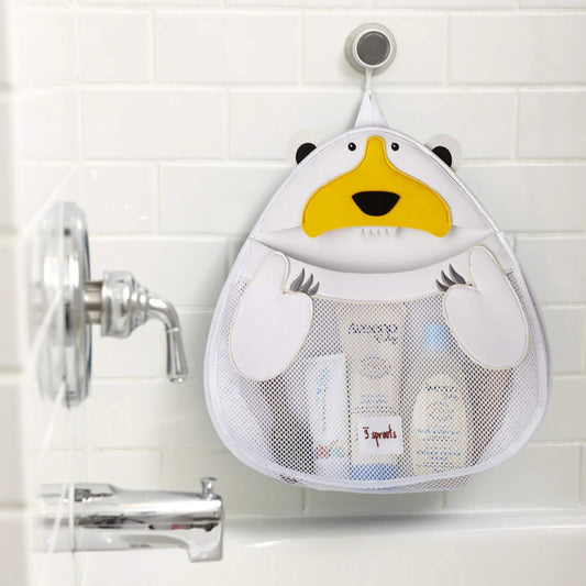 Polar bear bath storage organiser in use, attached to tiled wall above bathtub and filled with baby bath products in the mesh pouch.