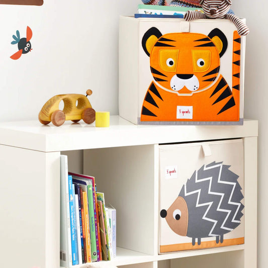 3 Sprouts hedgehog storage box displayed in a cube shelf unit beside books and a tiger box, filled with toys and soft books.