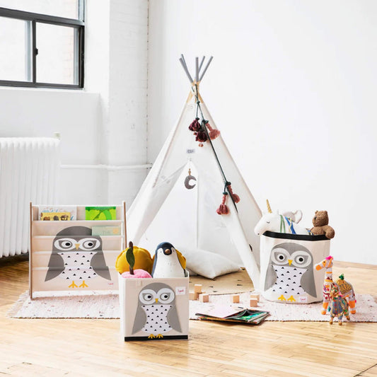 The owl storage box shown in a child’s playroom, styled alongside a matching owl book rack and a round play tent.