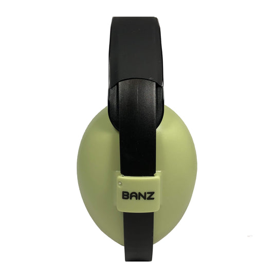A side view of green and black baby earmuffs showing the BANZ logo and padded headband.