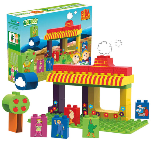 A colourful farm building made from bright stacking blocks, shown assembled with character pieces, a tree and illustrated scenery.