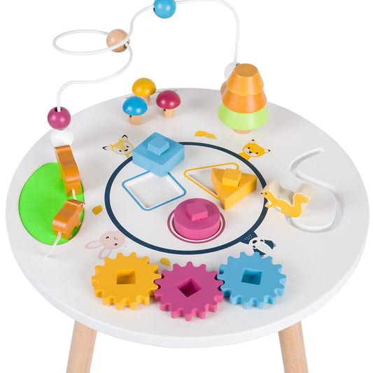 Top-down view of the activity table with a bead maze, spinning cogs, shape sorter, and stacking tree for early learning.