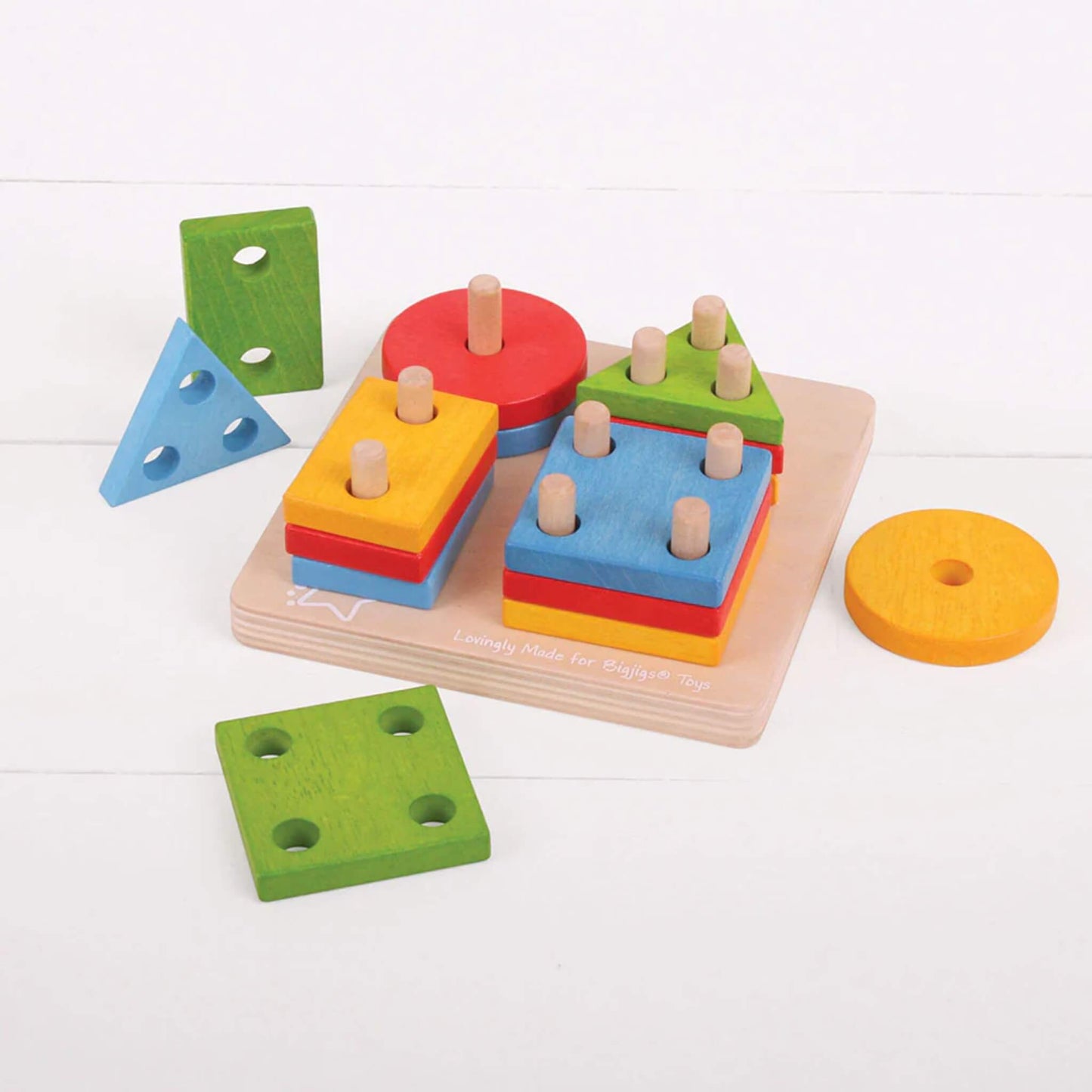 Wooden shape sorting pieces stacked and organised on the pegged baseboard – perfect for little hands learning to sort and match.