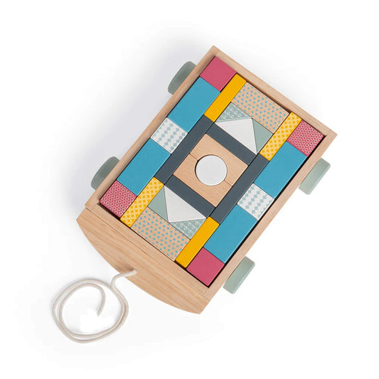 Top view of wooden brick cart packed with geometric building blocks.