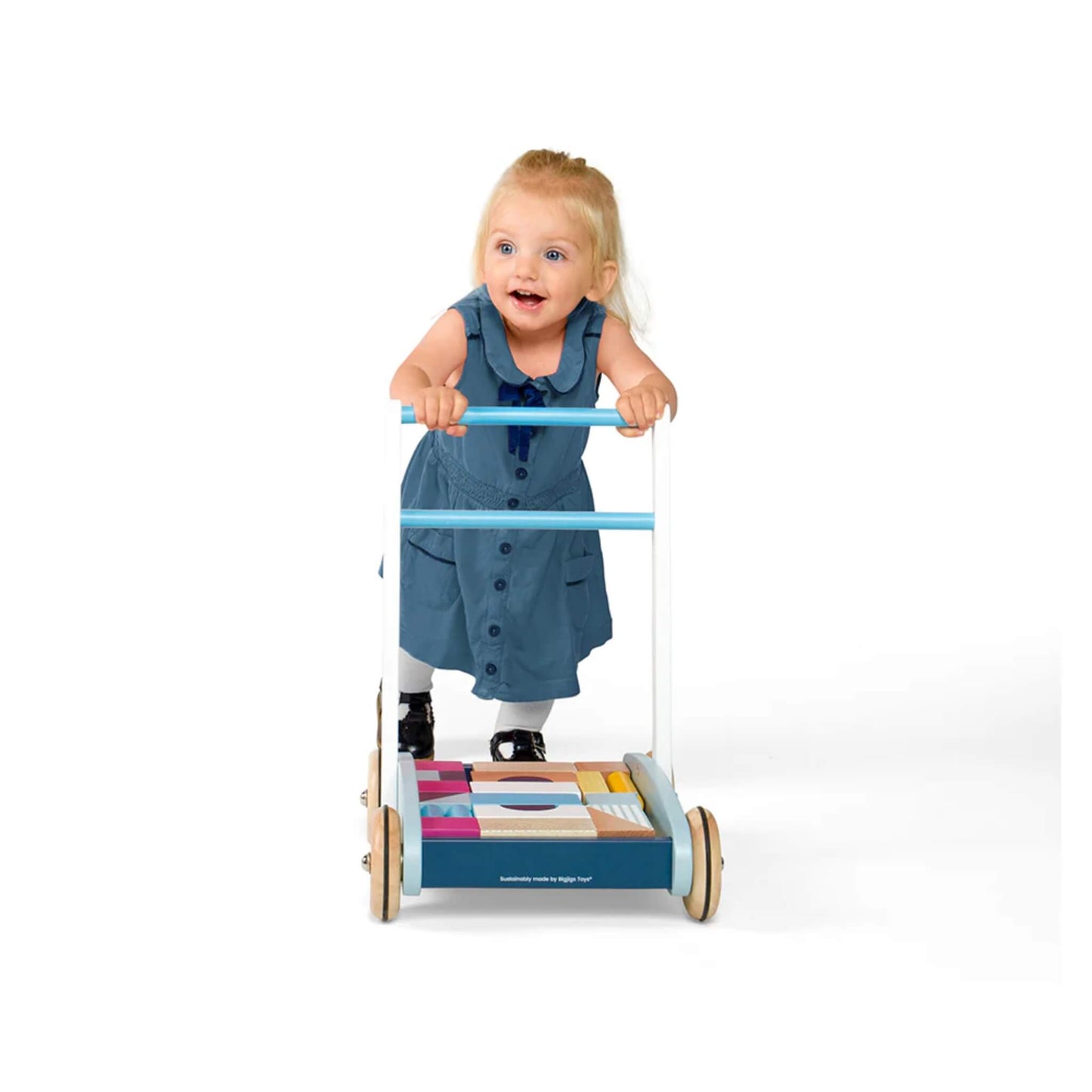 Child in a blue dress enjoying their first steps with the sturdy baby walker.