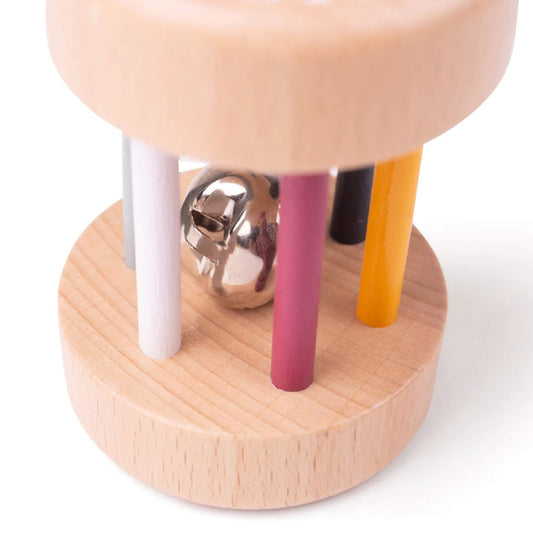 Close-up of the FSC® Certified Wooden Roll Rattle showing the shiny bell inside and painted bars in muted rainbow tones.