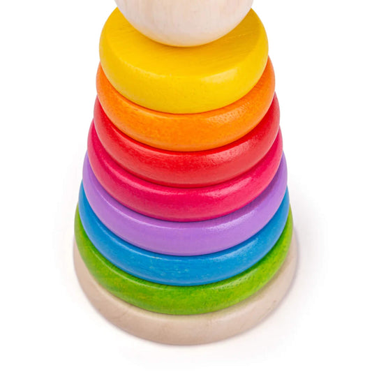 Close-up of brightly coloured wooden rings stacked in a rainbow pattern – perfect for little hands.