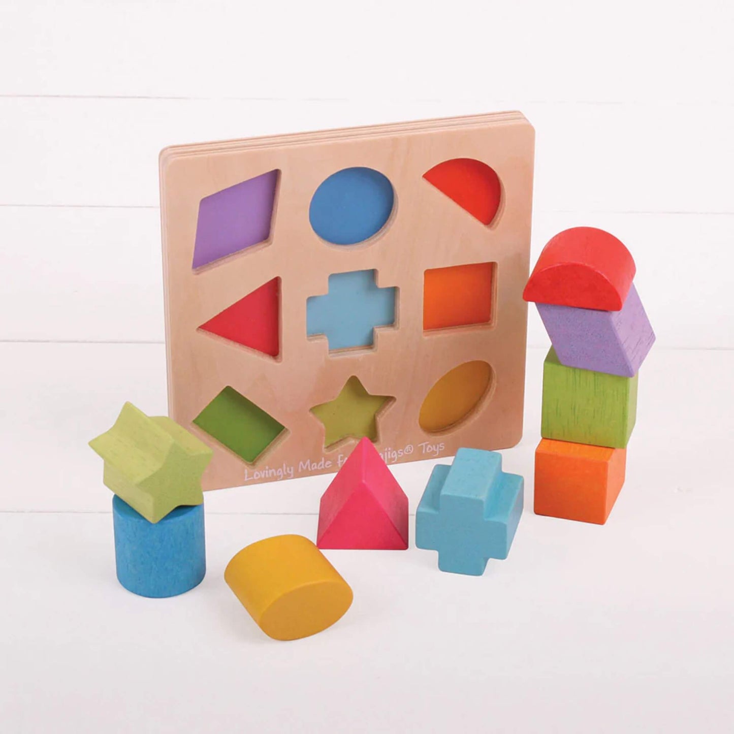 Bigjigs Toys First Shapes Sorter with wooden shapes stacked and sorted, encouraging early problem-solving and hand-eye coordination.