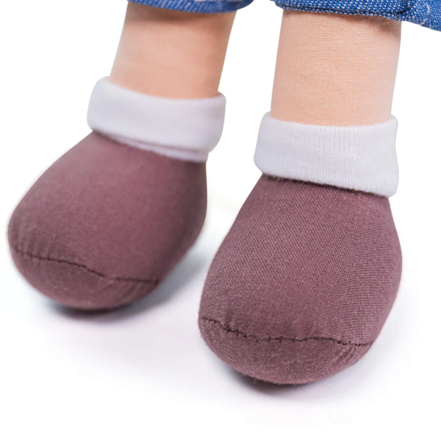 Close-up of the doll’s brown stitched shoes and white ankle cuffs, showing the bottom half of the outfit and doll’s legs.