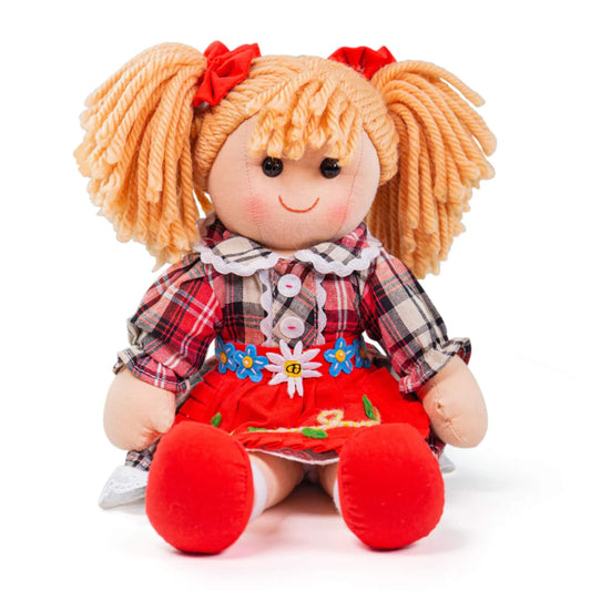 Mandie doll sitting upright, showing her red apron skirt, red shoes and soft yarn pigtails with red bows.