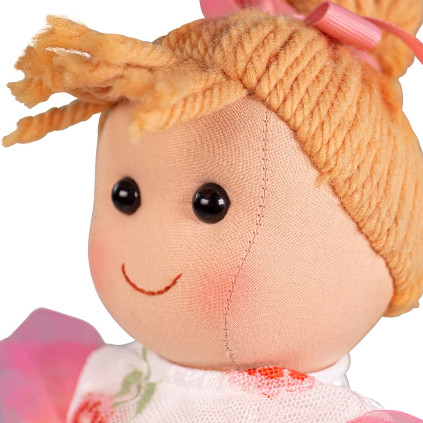Soft stitched features with rosy cheeks and shiny black eyes.