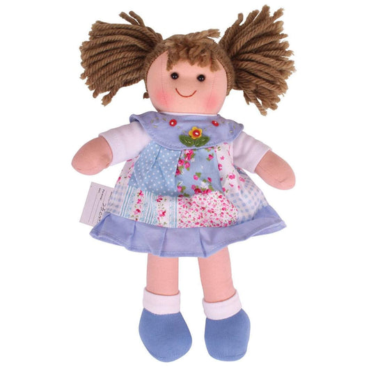 Front view of soft ragdoll in a floral patchwork-style blue dress, with bright blue shoes and plaited yarn hair tied in pigtails.