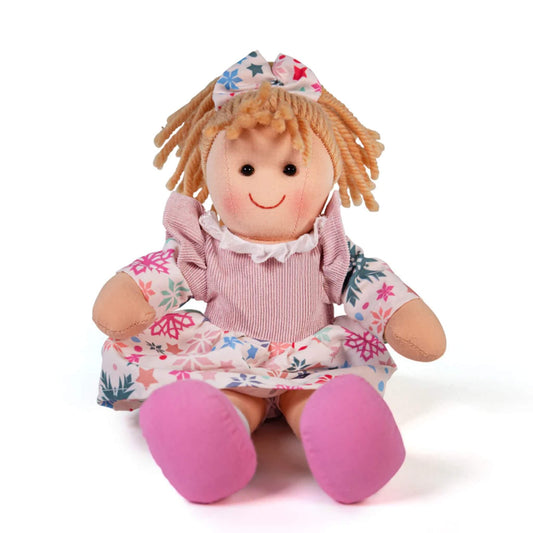 Shannon doll seated, showing her pink cord dress with ruffled collar and printed sleeves.