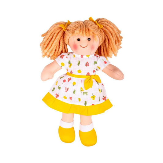 Close-up of Zoe Doll showing her smiling face, yellow bow details and printed dress with a bright yellow trim.