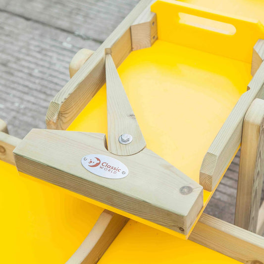 Close-up of a yellow water play tray with a wooden handle section from the outdoor water play set.