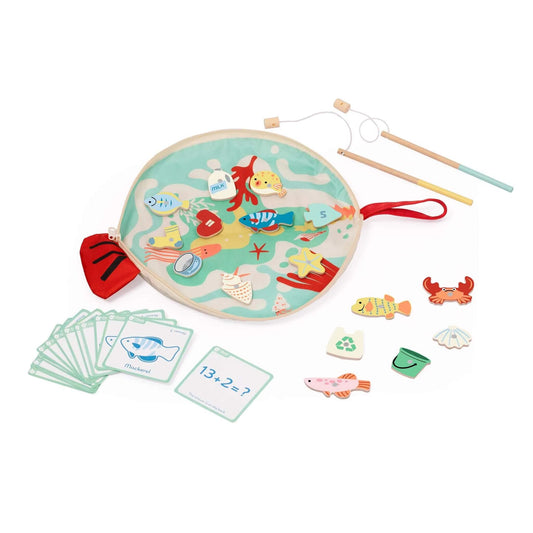 Round play mat with colourful ocean scene, wooden sea animals, pretend rubbish pieces, two magnetic fishing rods, and number and picture activity cards spread out.