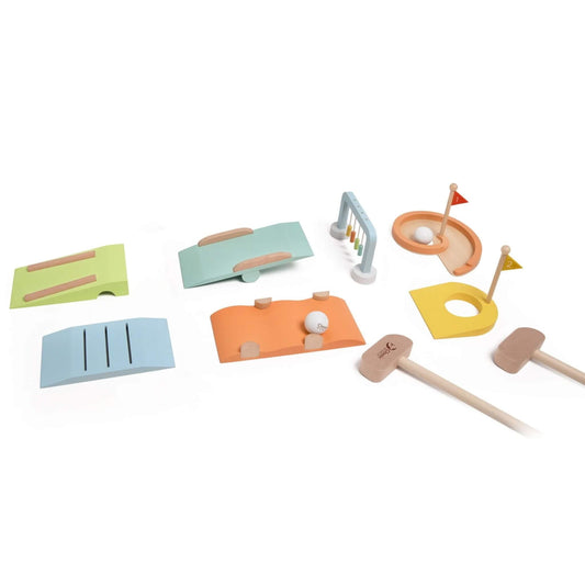 Wooden toy golf set pieces laid out on a white surface, including green, orange, and blue curved ramps with grooves for golf balls to roll down.