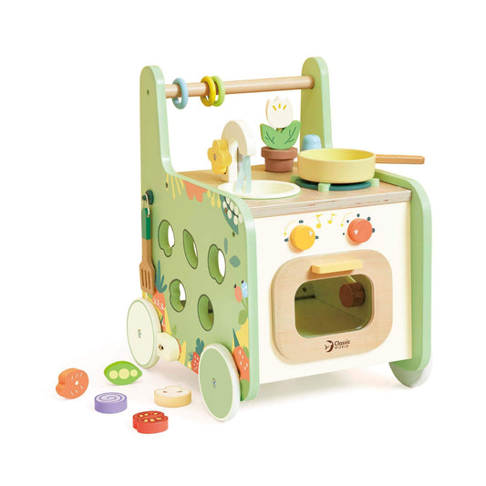 Angled view of a wooden pastel walker with a play stove, sink, floral details, and shape sorter holes on the side.