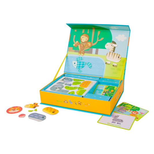 Wooden magnetic animal pieces and scene cards displayed inside a fold-out storage box with illustrated forest backdrop.