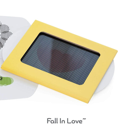 Close-up of a yellow-framed animation card viewer with striped overlay showing a hidden heart illusion, with the words "Fall In Love~" below.