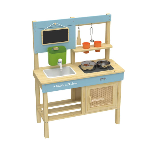 Side view of a wooden outdoor kitchen featuring a blue frame, white sink, green bucket, blackboard, metal pots, wooden spatula, ladle, and orange cups on shelves.