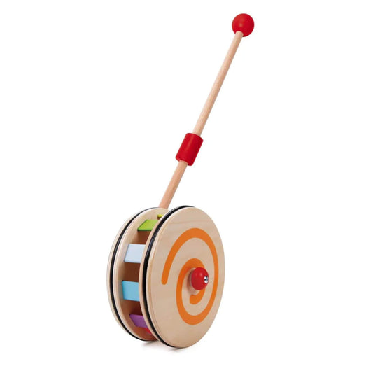 Wooden push toy with orange spiral detail on one wheel and colourful paddles inside, attached to a natural wood stick with a red grip and knob.