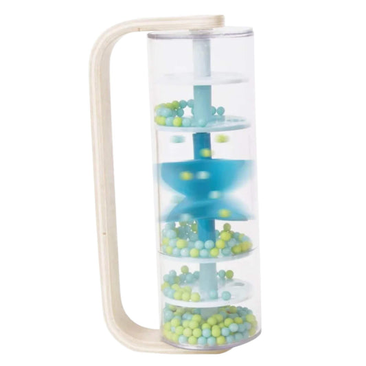 Close-up of an upright blue rainmaker with spiral spinner and pastel beads inside a clear tube, mounted on a wooden frame.