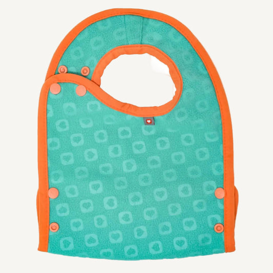 A reversible baby bib shown from the back with a soft teal fleecy surface, orange edging and multiple side poppers for adjustable fastening.