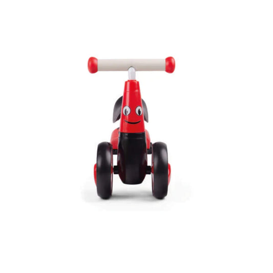 Straight-on image showing the friendly ladybird face with eyes and a smile on the red frame, plus wide black front wheels for stability.