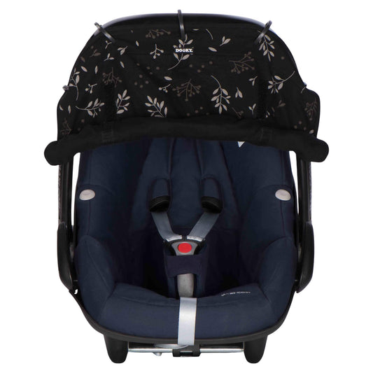 A dark baby car seat fitted with a black leaf-patterned sunshade secured along the canopy using five rings, with the lower edge softly gathered and velcroed at the sides.