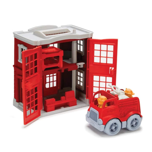 Firehouse doors opened to reveal two-storey interior with bunk beds, desk, pole and control centre, with fire engine and cat figures ready for play.