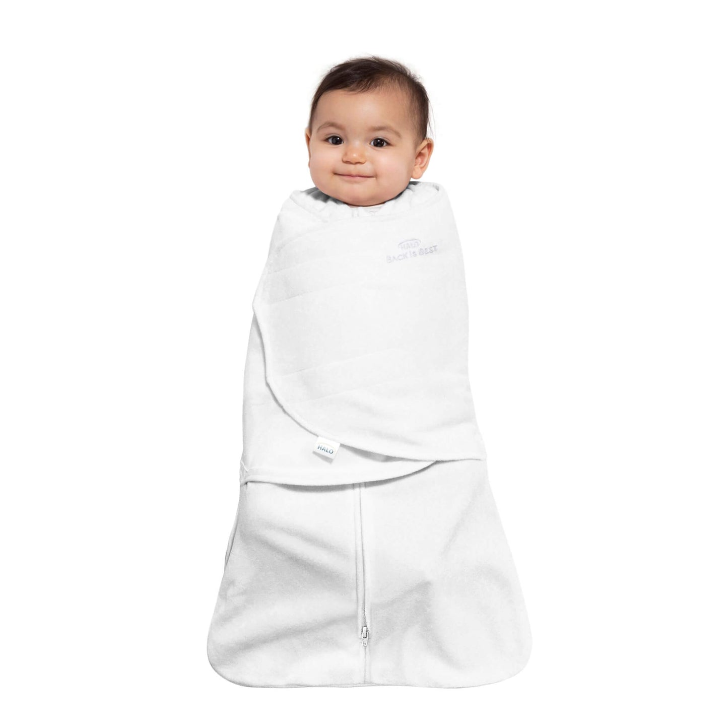 Smiling baby swaddled in HALO White SleepSack.