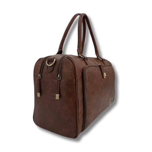 Side view of the Isoki Redwood Chestnut changing bag showing zip closures, curved seams, and carry handles.