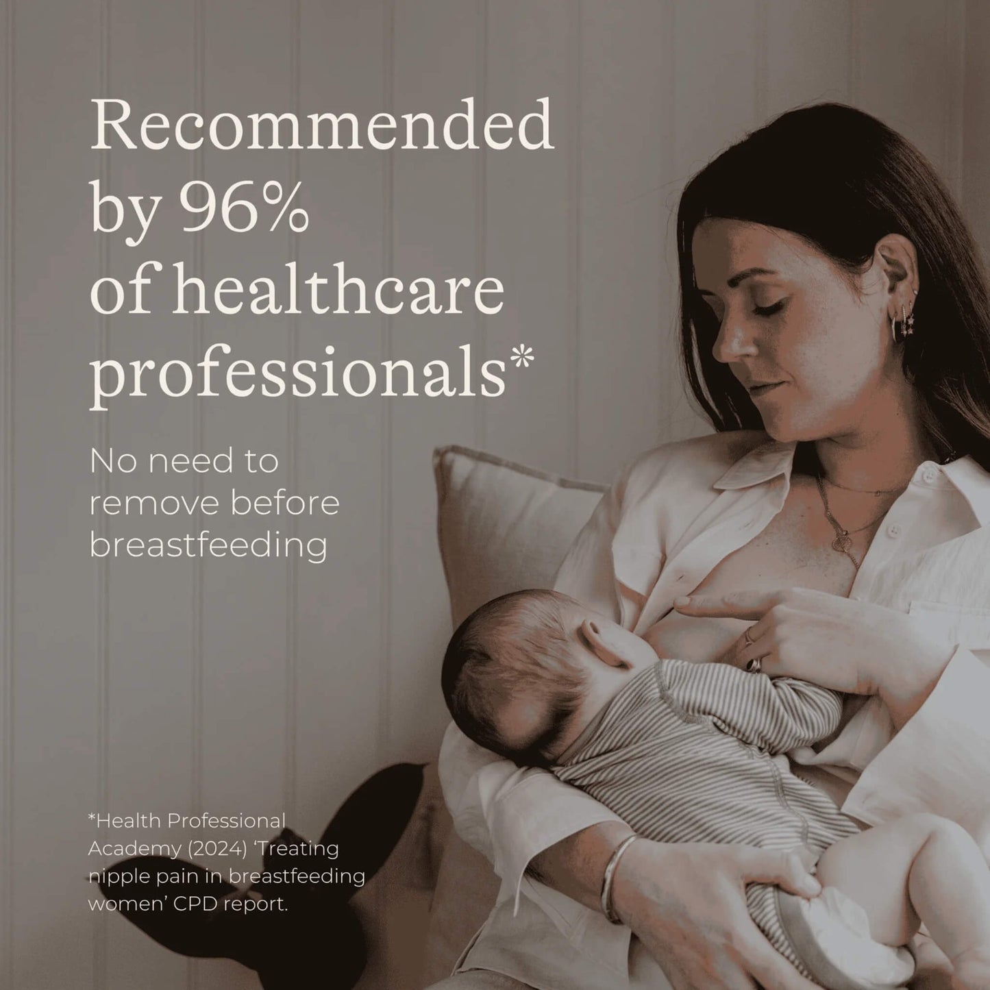 Mother breastfeeding her baby while sitting on a sofa, representing the lanolin nipple cream being safe to use without removal before feeding.