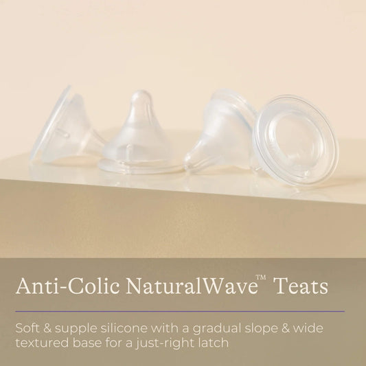Four clear silicone baby bottle teats displayed in a row on a neutral background with information highlighting soft silicone, gradual slope and wide textured base design.