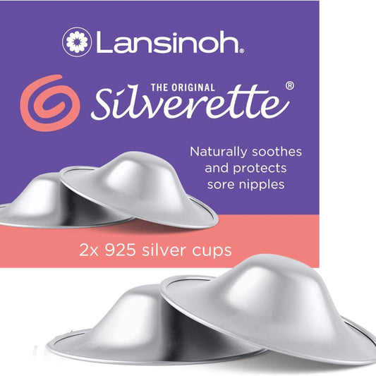 Lansinoh Silverette Silver Nursing Cups shown in front of purple and coral packaging, featuring two concave 925 sterling silver cups designed to soothe and protect sore nipples naturally.