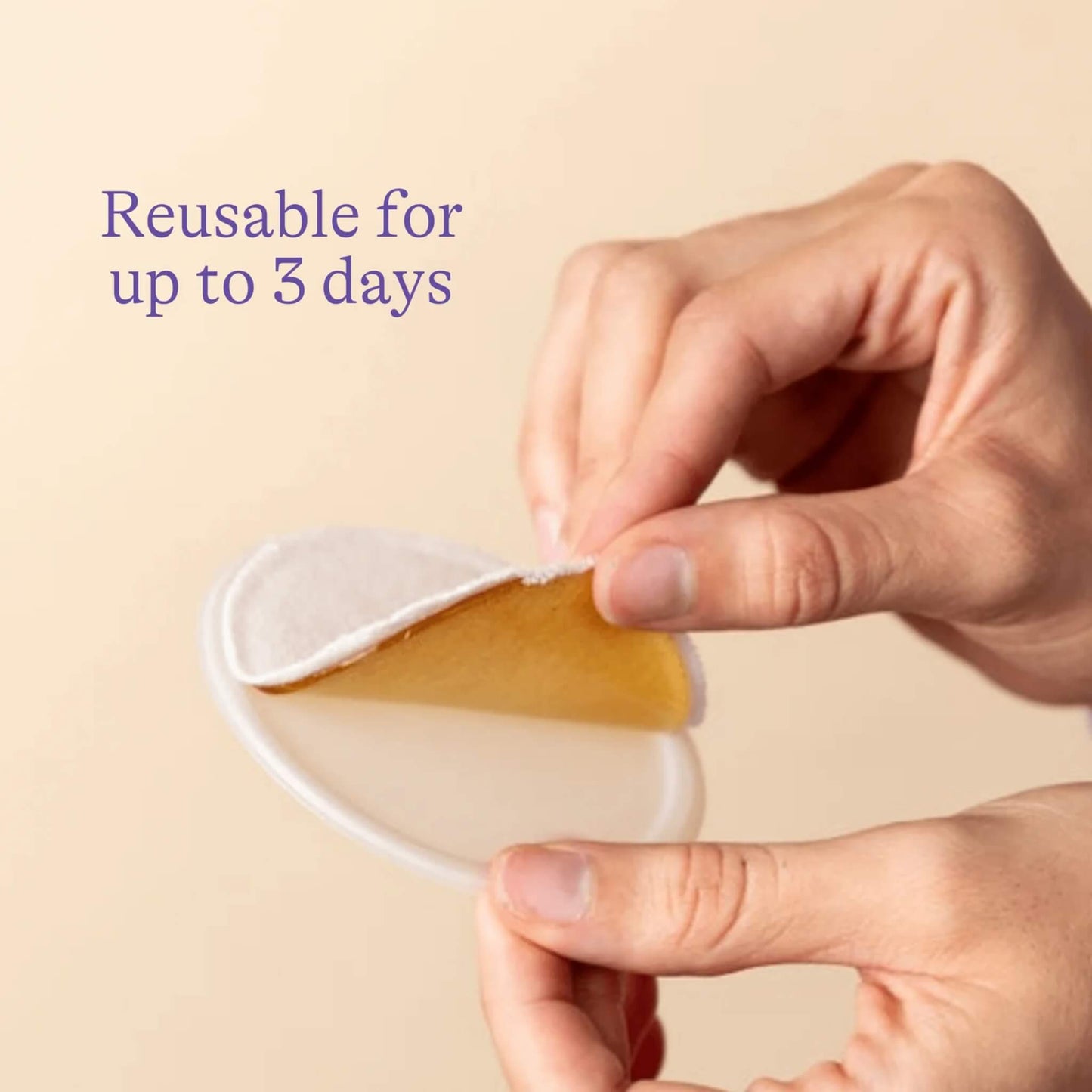 Hands holding and peeling apart a breastfeeding cooling gel pad to show the soft hydrogel layer and reusable design suitable for up to three days of use.