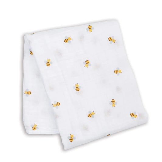 Lightweight muslin swaddle laid flat, showing the repeating bee pattern across the white cotton fabric.