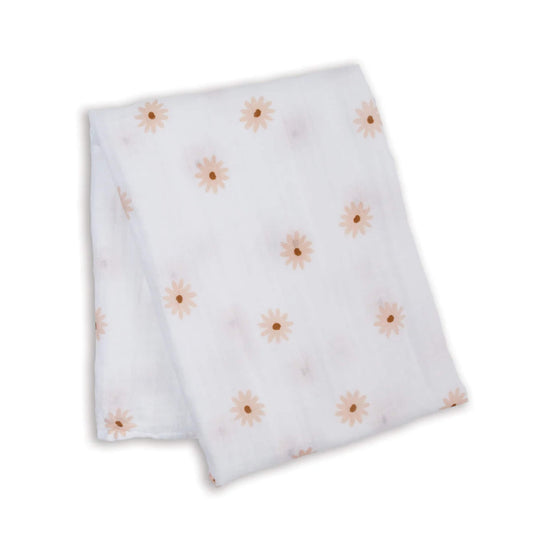 Lightweight muslin swaddle folded flat, showing a scattered pattern of soft peach daisies across the white cotton fabric.