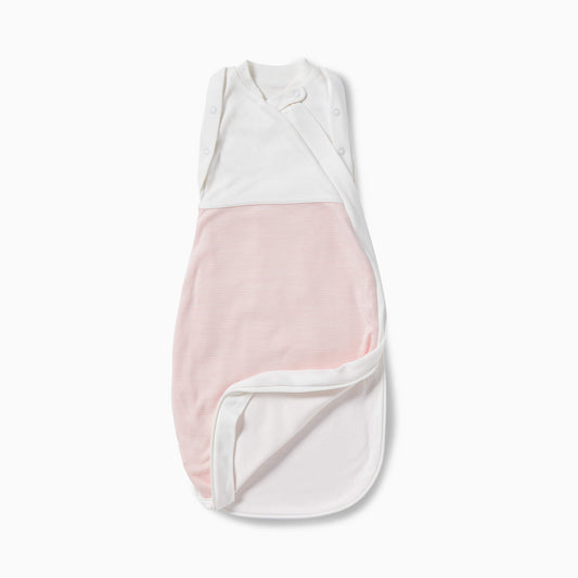 A soft white and blush striped newborn swaddle bag laid flat with the lower section partly folded open to show the smooth interior lining.