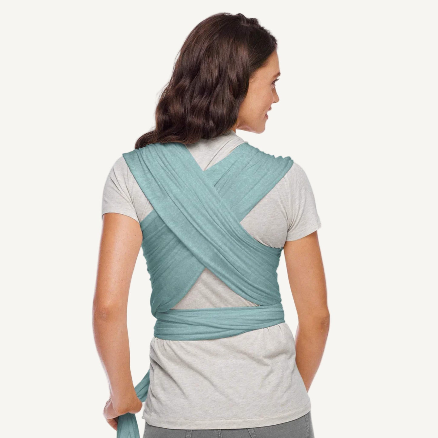 Back view of an adult wearing a teal wrap with fabric crossed over the shoulders and tied securely around the waist.