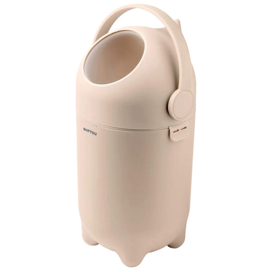 Side view of a beige nappy bin, showing its ergonomic handle and modern, neutral-toned design.