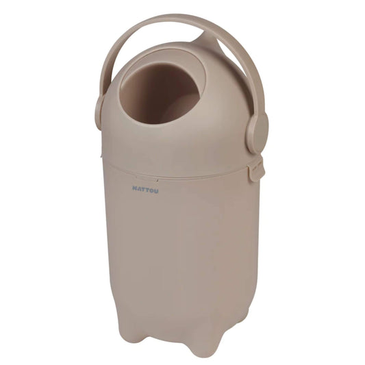 Side view of a taupe nappy bin, showing its ergonomic handle and simple, neutral-toned design.
