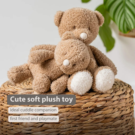 Two beige teddy bears made from soft textured fabric resting on a woven basket, shown with the text ‘Cute soft plush toy’, ‘ideal cuddle companion’ and ‘first friend and playmate’ on the image.