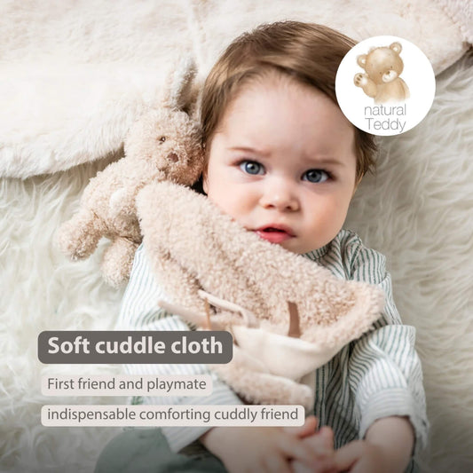 Baby holding a beige cuddle comforter with an attached plush bunny, shown with the text ‘Soft cuddle cloth’, ‘First friend and playmate’, and ‘indispensable comforting cuddly friend’ on the image.