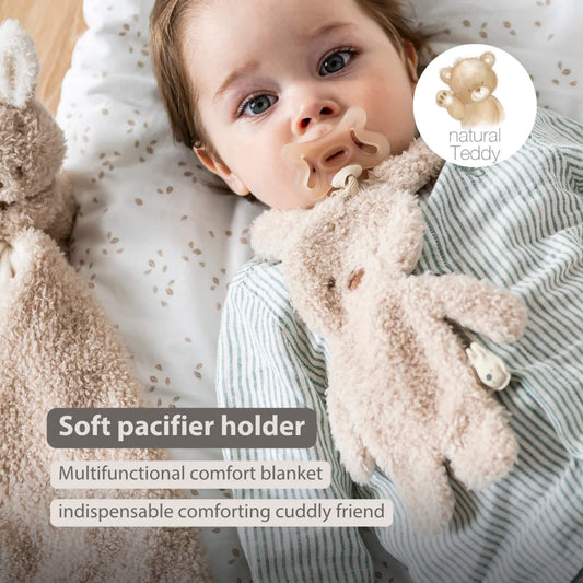 Baby lying down while holding a soft plush bunny pacifier holder, shown with the text ‘Soft pacifier holder’, ‘Multifunctional comfort blanket’ and ‘indispensable comforting cuddly friend’ on the image.