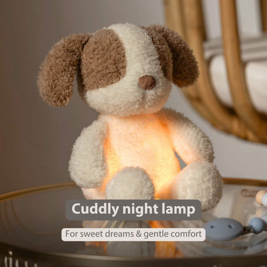 A small plush dog nightlight sitting on a bedside table with a warm amber glow shining through its body.