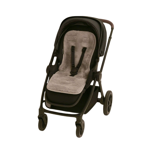 Grey baby sheepskin Pram Liner fitted inside a modern black pushchair with harness straps threaded through.