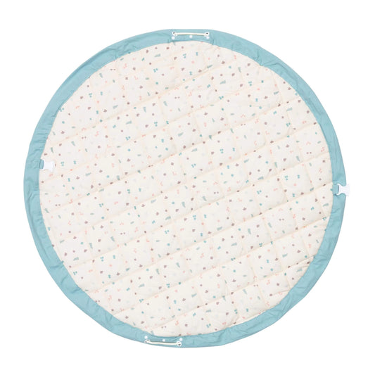 A padded circular play mat shown from the reverse side with a subtle all-over pastel pattern and stitched sections for comfort.