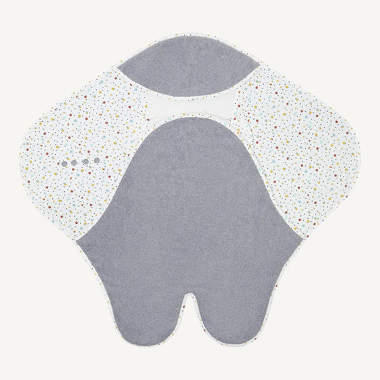 Opened up baby travel blanket showing grey centre panel, leg split at the bottom, white cotton wings in a multicoloured spot print and mesh-lined head section with popper fastenings.